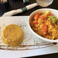 Mofongo on left, rice & veggies on right   at Edelweiss Bar & Grill in Luquillo