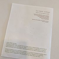 Tip free policy printed on the back of the menu at Acorn Community Cafe in Eugene