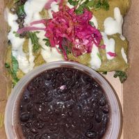 Roasted poblano, jalapeño, tomatillo sauce blended with cashew creama, stuffed with black bean, mushroom, spinach, onion & cashew cheese, creamy &  side of black beans   at Vida Cantina SF in San Francisco