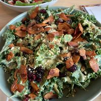 Kale salad is absolutely delicious. I wanted to lick my plate clean. Dijon tahini dressing with coconut flake bacon. 😋  at Mondays Plant Café in Calgary
