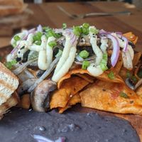 Vegan chilaquiles with potato "queso" at Yum Yum San Pancho in San Francisco