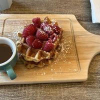 Vegan waffle with maple syrup and raspberries   at Love Peace & Coffee in Edinburgh