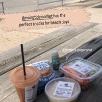 Fresh custom juice, hummus, carrots and celery, ginger juice shot, and pretzels   at Rising Tide Natural Market in Glen Cove