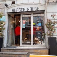 Outside, tables and chairs not pictured behind me at Burger House in Belgrade