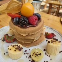 Vegan pancakes with chocolate spread and fresh fruit at Nibs Healthy Bar in Menorca