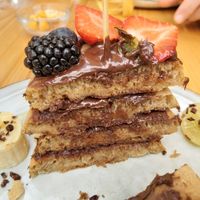 Vegan pancakes with chocolate spread and fresh fruit at Nibs Healthy Bar in Menorca