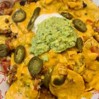 The nachos (with heaps of toppings) were yummy. at Cow's Revenge Vegan in Panama City