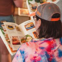 The menu look like a magazine at iVegan Supershop Da Nang - Healthy Plant Based Cafe in Da Nang