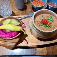 Lobio (bean stew), pickles, and adjika & tkhemali sauces in the background at Kartuli in South East London