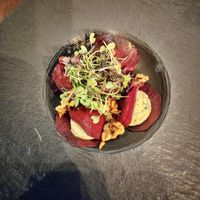 Raw beetroot ravioli, cashew cheese with yellow pepper sauce and walnuts.  at Ca n'Ela Vegan Restaurant in Mallorca