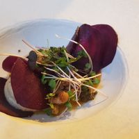 Raw beet ravioli stuffed with cashew cheese and herbs with roasted yellow peppers sauce at Ca n'Ela Vegan Restaurant in Mallorca