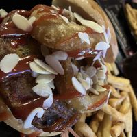 Dodge with veggy burger onion rings and almonds   at Unic Bar in Vanzago