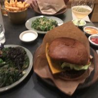 Burger, side dishes lots of sauces and drinks  at POPL Burger in Copenhagen