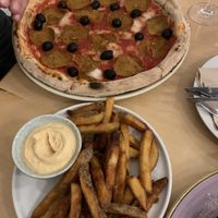 Pizza pepperoni with olives and a side fries  at Chutnej in Prague