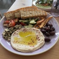 Antipasti - bread, hummus, vegan cheese, olives, pickled carrots ,cucumbers, and tomatoes.  at Chutnej in Prague