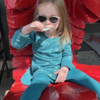 Toddler enjoying vegan arctic mint ice cream   at Ben & Bill's Chocolate Emporium in Bar Harbor