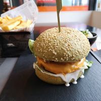 Burger with vegan cheddar, fries and a side salad at Reed in Luxembourg City
