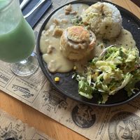 Local luxembourgian dish with a blue lagoon mocktail  at Reed in Luxembourg City