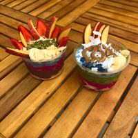 A smoothie bowl with a base of acai, pitaya, and blue majik and another smoothie bowl with a base of pitaya, power greens, and blue chia pudding. at Terra Superfoods in Monterey