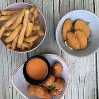 Chips (French fries) plant chili nuggets and (cauli)flower wings with hot sauce  at Junk y Vegan in Helsinki