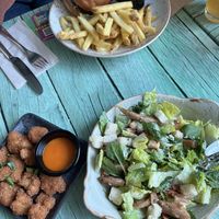 Cauliflower bites with hot sauce, Caesar salad, and portobello burger    at Junk y Vegan in Helsinki