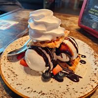 Croffle: vanilla oat ice cream between croissant waffles, berries, choco sauce & whipped cream (8.5€) at Junk y Vegan in Helsinki