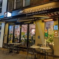 Exterior with some outside tables at Tofu Vegan - Islington in North London