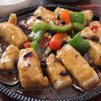 Sizzling fried tofu in a black bean sauce. 
I’d suggest a side of rice with this. at Tofu Vegan - Islington in North London