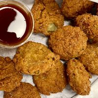 Deep Fried Pickles! They are salty, crispy, and awesome with both sweet heat sauce (pictured) and ranch 💚  at Herbie Butcher's Fried Chicken in Minneapolis