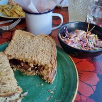 Sausage sarnie with slaw and sweet potato fries- delicious 😄 at Lounges - Tretho Lounge in St Ives