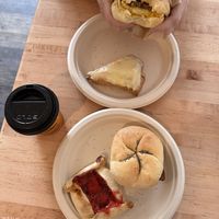 Breakfast sandwich: egg, cheese, bacon, and ketchup on Kaiser roll ($9), orange scone ($4), strawberry rhubarb crostata ($7), 8oz drip coffee ($3.50)   at New Moon Vegan in Batavia