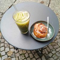 Cold matcha latte with vegan cinnamon roll at Calm Coffee in Berlin