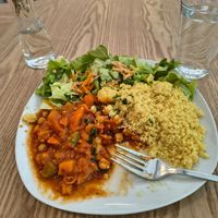 Moroccan Tajin Stew with vegetables of the season, chickpea, couscous and salad at Sattva Vegan in Vienna