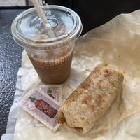 The “Hall & Oat” cold brew (cinnamon, vanilla, oat milk) plus the vegan burrito  at Gregory's Coffee - 6th Ave in New York City