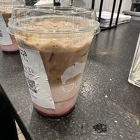 Rainbow cookie latte made vegan  at Gregory's Coffee - 6th Ave in New York City