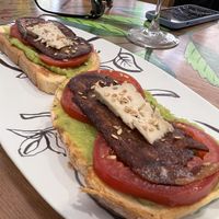 Avocado on toast with tomato, vegan bacon and vegan cheese   at Contracorriente in Ourense