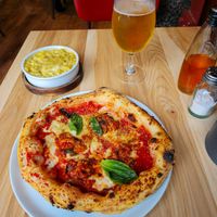 Aubergine parmigiana pizza, mac & cheese with a bottle of offensively bland chilli oil and salt dispenser at Purezza in Manchester