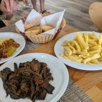 Aubergine, fries, stuffed peppers (already being eaten) at Eni Traditional Food in Berat