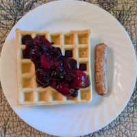 Belgian waffle with berry compote and a sausage at Gardenview Estate Bed & Breakfast in Kettle Falls