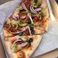 Personal size pizza with vegan cheese, vegan sauce, green pepper, olives, and onions. The personal size equates to 4 regular sized slices of pizza.  at Vinny's Pizza Joint in Kitty Hawk