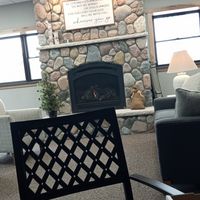 Cafe style seating. Stay warm by the fire. at Nature's Nest in Grayling