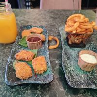 Nuggets with BBQ sauce, twister fries with garlic mayo and fresh orange juice at Vegan Temple Bar in Amsterdam