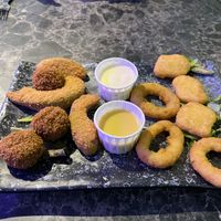 Sample platter with onion rings, bitterballens, fried avocado, and nuggets- with honey mustard and mayo.  at Vegan Temple Bar in Amsterdam