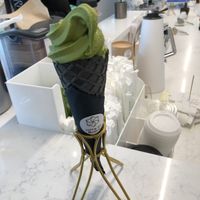 Matcha soft serve ice cream in charcoal cone at Whisk Matcha Cafe in Vancouver