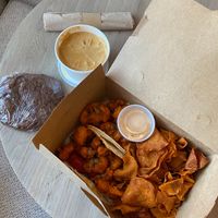Buffalo Cauliflower Tacos, Sweet Potato Chips, Vegan Queso, and A big Chocolate Almond Chunk Brownie  at Laughing Seed Cafe in Asheville