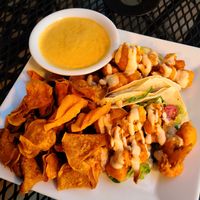 Buffalo tacos with sweet potato chips and a side of queso at Laughing Seed Cafe in Asheville
