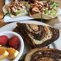 Vegan Ruben with Fruit and Buffalo Cauliflower Tacos with Jalapeño Onion Fries at Laughing Seed Cafe in Asheville