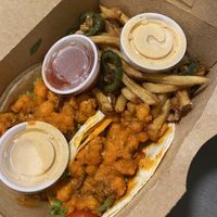 Buffalo cauliflower tacos. Side of jalapeño fries and vegan ranch  at Laughing Seed Cafe in Asheville