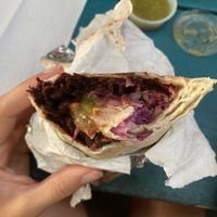 Burrito w barbacoa and a side of salsa verde   at Gutierra in Atlanta