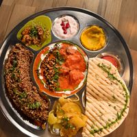 A thali plate including roast beetroot & carrot dhal with a peanut crum. gratin potato with lime & chill, Goan spinach cafreal sauce with roast loveland squash and more.  at Wilder   in Falmouth